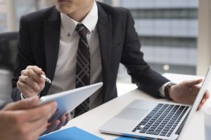 Two young businessman, looking at the tablet in the office